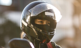 Close-up of a motorcycle rider wearing a helmet